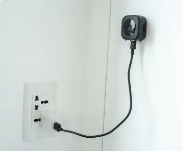 GuardHouse camera charging beside a wall outlet