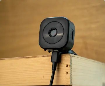 GuardHouse camera sitting on a wooden shelf indoors